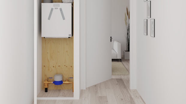 Utility alcove in a hallway with a wall-mounted white boiler on plywood backing and copper pipes at floor, opening to a bright living area.